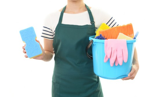 Professional cleaner following safe working practices during routine cleaning duties.