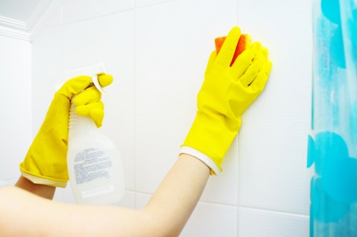 Cleaner using PPE during a cleaning task