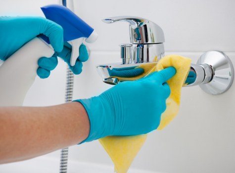 Cleaner reviewing service scope and access details before starting work